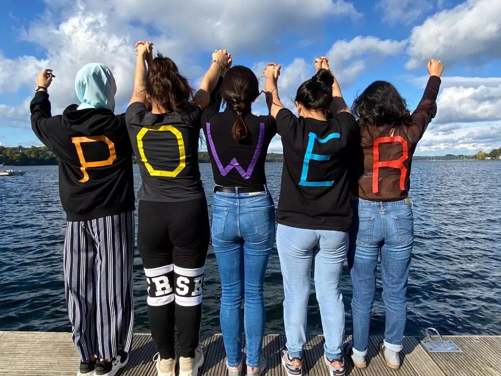 Group of people with the word power on their shirts